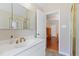 Bathroom featuring a sink, medicine cabinet, and shower; bedroom in background at 821 Woodburn Rd, Raleigh, NC 27605