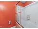 Bathroom featuring orange walls, tub with glass shower door and updated fixtures at 821 Woodburn Rd, Raleigh, NC 27605