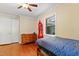 Bedroom features a bed, red clock, and hardwood floors at 821 Woodburn Rd, Raleigh, NC 27605