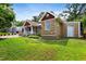 Well-maintained house showcasing stone accents, a tidy lawn, and a detached garage at 821 Woodburn Rd, Raleigh, NC 27605
