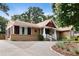 Inviting home featuring a circular driveway, appealing facade, and a well-kept lawn at 821 Woodburn Rd, Raleigh, NC 27605