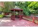 Backyard deck with a covered gazebo and seating, creating a relaxing outdoor space at 821 Woodburn Rd, Raleigh, NC 27605