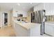 Bright kitchen with stainless steel appliances, white cabinets, and granite backsplash at 821 Woodburn Rd, Raleigh, NC 27605