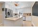 Bright kitchen with stainless steel fridge, white cabinets, kitchen island, and stainless steel appliances at 821 Woodburn Rd, Raleigh, NC 27605