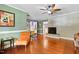 Bright living area with an exposed brick fireplace, hardwood floors, and ample seating at 821 Woodburn Rd, Raleigh, NC 27605