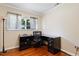 Home office featuring a desk, chair, hardwood floors and a window at 821 Woodburn Rd, Raleigh, NC 27605