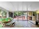 Sunroom with large glass doors that open to an outdoor deck and landscaped backyard at 821 Woodburn Rd, Raleigh, NC 27605