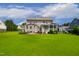 Expansive backyard features a well-maintained lawn and a charming patio with outdoor seating at 8909 Tara Hill Ln, Wake Forest, NC 27587