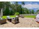 Beautiful backyard patio with stone pavers, comfortable outdoor furniture and a built-in fire pit at 8909 Tara Hill Ln, Wake Forest, NC 27587