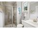 Bathroom with a glass shower, a window, and a seahorse wall decoration at 8909 Tara Hill Ln, Wake Forest, NC 27587