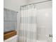 Bathroom features a shower with a white and grey curtain, tile surround, and chrome hardware at 8909 Tara Hill Ln, Wake Forest, NC 27587