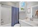 Bathroom featuring shower-tub combo with blue-striped curtain and a vanity with a white countertop at 8909 Tara Hill Ln, Wake Forest, NC 27587