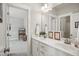 Bathroom featuring double vanity with framed mirrors and a view to another bedroom at 8909 Tara Hill Ln, Wake Forest, NC 27587