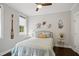 Bright bedroom with coastal decor, a ceiling fan, and natural light from two windows at 8909 Tara Hill Ln, Wake Forest, NC 27587