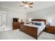 Large bedroom with a wooden bed frame, two nightstands, and a dresser at 8909 Tara Hill Ln, Wake Forest, NC 27587