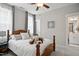 Bedroom features a plush bed, ceiling fan, and an ensuite bathroom at 8909 Tara Hill Ln, Wake Forest, NC 27587