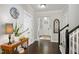Entryway with dark hardwood floors, neutral walls, staircase and decorative accents at 8909 Tara Hill Ln, Wake Forest, NC 27587