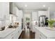 Well-lit kitchen with stainless appliances, white cabinets, an island, and a view into the dining room at 8909 Tara Hill Ln, Wake Forest, NC 27587