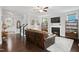 Cozy living room with dark hardwood floors, a leather sofa, and a fireplace as a focal point at 8909 Tara Hill Ln, Wake Forest, NC 27587