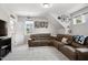 Spacious living room features plush seating, natural light, and carpeted floors at 8909 Tara Hill Ln, Wake Forest, NC 27587