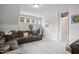 Spacious living room featuring plush seating, neutral walls, carpeted floors, and bright windows at 8909 Tara Hill Ln, Wake Forest, NC 27587