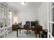 A well-lit home office space with a wooden desk, comfortable chair, and neutral carpet at 8909 Tara Hill Ln, Wake Forest, NC 27587