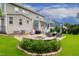 Backyard patio with built-in fire pit, seating, grill, and well-manicured landscaping at 8909 Tara Hill Ln, Wake Forest, NC 27587