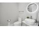 Beautiful powder room offering a vessel sink, modern faucet and round mirror with lighted trim at 8909 Tara Hill Ln, Wake Forest, NC 27587