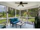 Relaxing screened-in porch providing a ceiling fan, comfortable seating, and views of the landscaped yard at 8909 Tara Hill Ln, Wake Forest, NC 27587