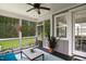 Relaxing screened-in porch providing a ceiling fan, comfortable seating, and views of the landscaped yard at 8909 Tara Hill Ln, Wake Forest, NC 27587