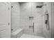 Stunning glass enclosed shower with a built-in bench, rainfall showerhead and tiled walls at 8909 Tara Hill Ln, Wake Forest, NC 27587
