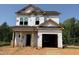 Two-story home features a garage, covered entrance, and is currently under construction at 95 Goldenrod Loop, Clayton, NC 27520