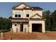 Two-story home under construction showing the frame with garage and a partially bricked foundation at 95 Goldenrod Loop, Clayton, NC 27520