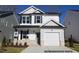 Charming two-story home featuring a white exterior, a garage, and a well-maintained front yard at 95 Goldenrod Loop, Clayton, NC 27520