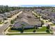 Expansive aerial view of gray houses, manicured lawns, and tree-lined streets in a well-planned neighborhood at 1000 Groveview Wynd, Wendell, NC 27591