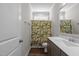 Cozy bathroom featuring patterned shower curtain, vanity and light at 1000 Groveview Wynd, Wendell, NC 27591