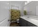 Bathroom features white sink, dark grey vanity and tropical themed shower curtain at 1000 Groveview Wynd, Wendell, NC 27591