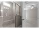 A tiled walk-in shower with a bench in a well-lit bathroom, designed for comfort and functionality at 1000 Groveview Wynd, Wendell, NC 27591