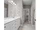 Bathroom with double vanity, modern fixtures, and a walk-in closet for storage and convenience at 1000 Groveview Wynd, Wendell, NC 27591