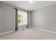 Bedroom with neutral walls, carpet, and a large window offering ample natural light and a cozy feel at 1000 Groveview Wynd, Wendell, NC 27591
