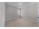 This is a carpeted bedroom with gray walls and a window with blinds and curtains at 1000 Groveview Wynd, Wendell, NC 27591