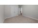 A bright bedroom featuring neutral carpet, gray walls, a pair of doors and white trim at 1000 Groveview Wynd, Wendell, NC 27591