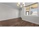 Bright dining area features modern chandelier, wood flooring and large window at 1000 Groveview Wynd, Wendell, NC 27591
