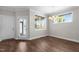 This dining area features wood flooring, a modern chandelier, and a door to the outside at 1000 Groveview Wynd, Wendell, NC 27591