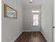 Entryway with wood-look floors, natural light, and white door to outside at 1000 Groveview Wynd, Wendell, NC 27591