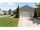 Charming home with a well-manicured lawn, two-car garage, and a screened-in porch at 1000 Groveview Wynd, Wendell, NC 27591
