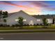 Exterior view of home showcasing lush lawn, manicured landscaping and attached side porch at 1000 Groveview Wynd, Wendell, NC 27591