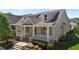 Charming two-story home with a welcoming front porch and lush landscaping at 1000 Groveview Wynd, Wendell, NC 27591