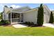 Well-manicured lawn with landscaping accents and a screened-in porch at 1000 Groveview Wynd, Wendell, NC 27591