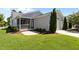 Well-manicured lawn with landscaping accents and a screened-in porch at 1000 Groveview Wynd, Wendell, NC 27591